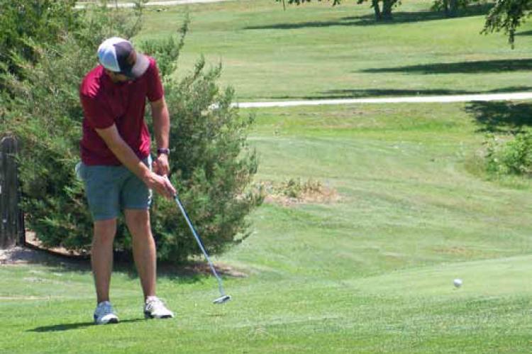 Mark Cunningham Jr. takes a putt Friday afternoon at the Ellsworth Golf Course on the way to completing 101 holes of golf in one day to raise funds for the Frances Claussen Charitable Foundation. Photos by ALAN RUSCH/ Ellsworth County Independent-Reporter