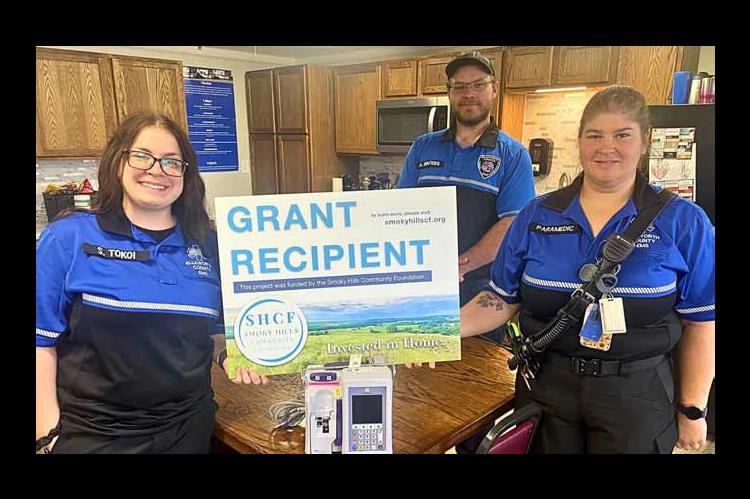 From left, EMT Scout Tokoi, paramedic Alex Winters and paramedic Elisabeth Mohler show the new IV pump purchased with grant funds. Courtesy photo