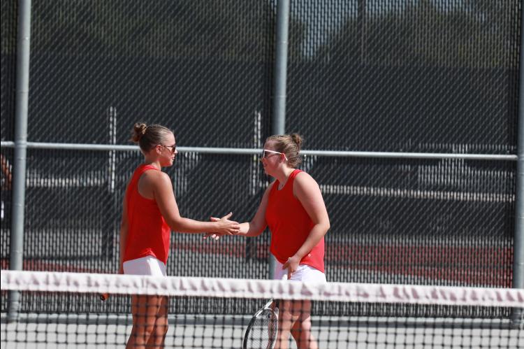 Junior Makenna Anderson, left, and senior Reygan Coonrod celebrate a point during the season opener in Ellsworth Sept. 1. 