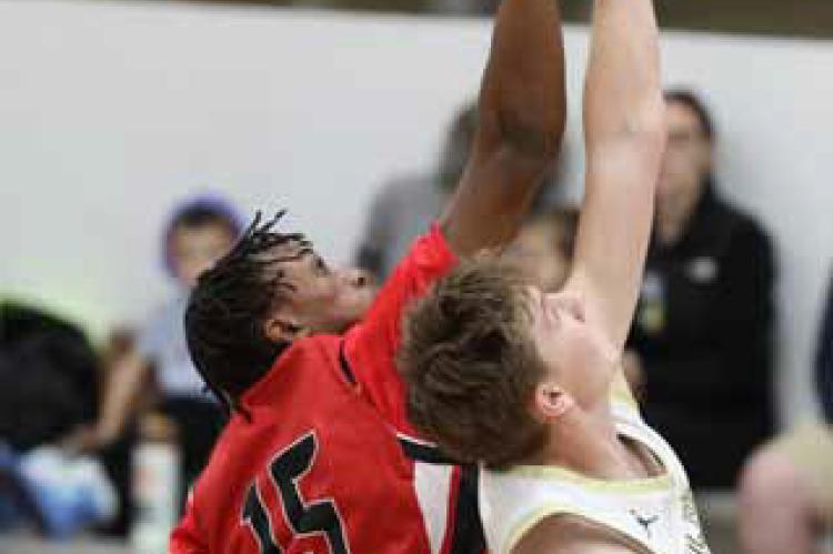 Cooper McGowan (15) competes for the tipoff against Sacred Heart Jan. 17 in Salina. KAREN BONAR/Ellsworth County Independent-Reporter