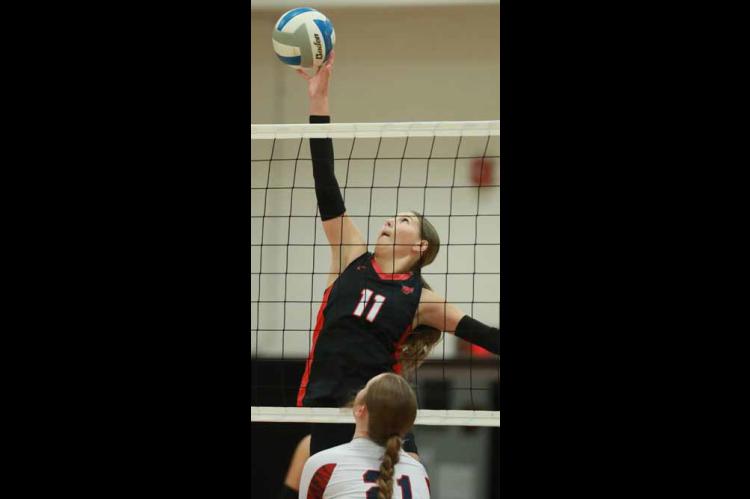 Senior Sydney Soukup attempts to block a shot during game one against Minneapolis Sept. 29. KAREN BONAR/Ellsworth County Independent-Reporter
