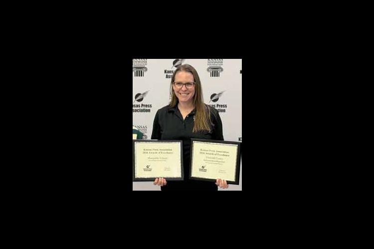 Karen Bonar displays sweepstakes awards for both the Ellsworth County Independent-Reporter and Marquette Tribune newspapers. WAYNE MIKOLS/Ellsworth County Independent-Reporter
