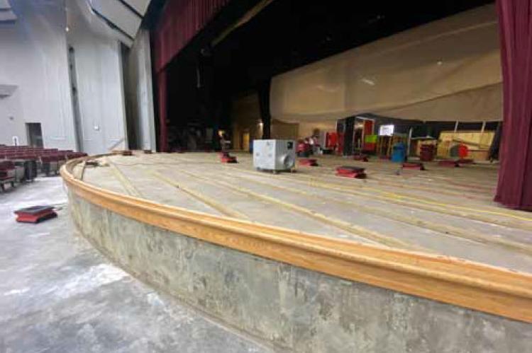 The stage flooring in the Performing Arts Center was removed to allow the surface to dry completely before new plywood is installed. Courtesy photo