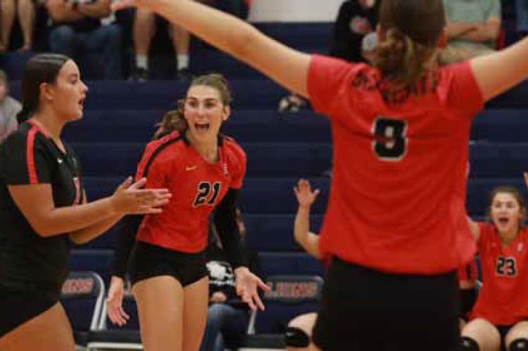 Seniors Kelli Rodriguez, left, and Elyse Haxton celebrate a point against the Minneapolis Lions Sept. 30 at Minneapolis.