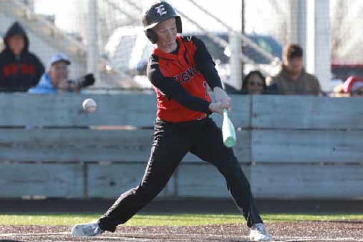 Macian Korbe swings at a ball during Game 1 against Sacred Heart in Salina March 27. KAREN BONAR/Ellsworth County Independent-Reporter