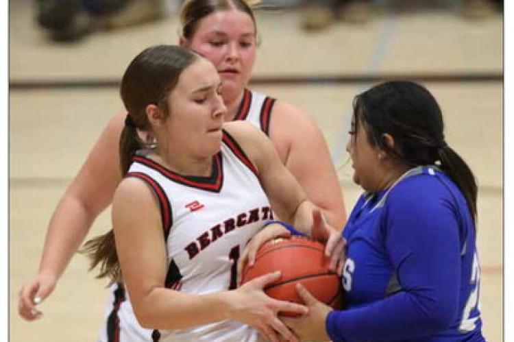 Kinly Place, left, attempts to wrestle a basketball away from Lyons opponent Joycelin Rascon. KAREN BONAR/ Ellsworth County Independent-Reporter
