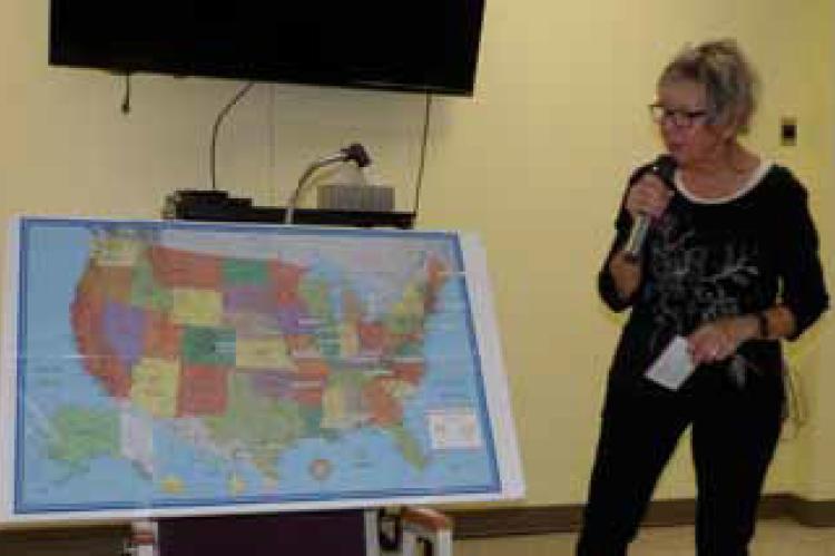 Ellsworth County Historical Society Board President Cynthia Edgerle uses a map of the United States to show various places where unsolved family murders, similar to the 1911 Showman family murders in Ellsworth, occurred. ALAN RUSCH/Ellsworth County Indepe