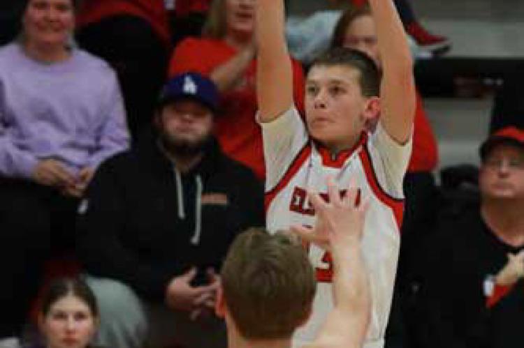 Ellsworth freshman Coulson Barta goes for 3 points over Republic County’s Grady Siemsen. KAREN BONAR/Ellsworth County Independent-Reporter