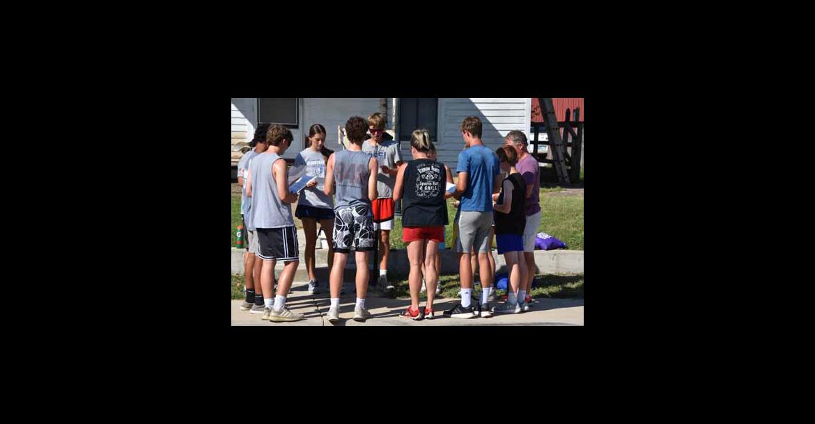 Prayer &amp; Action participants gather for a prayer before beginning work on a house near downtown Ellsworth. Photos by CATHERINE DOUD/Ellsworth County Independent-Reporter