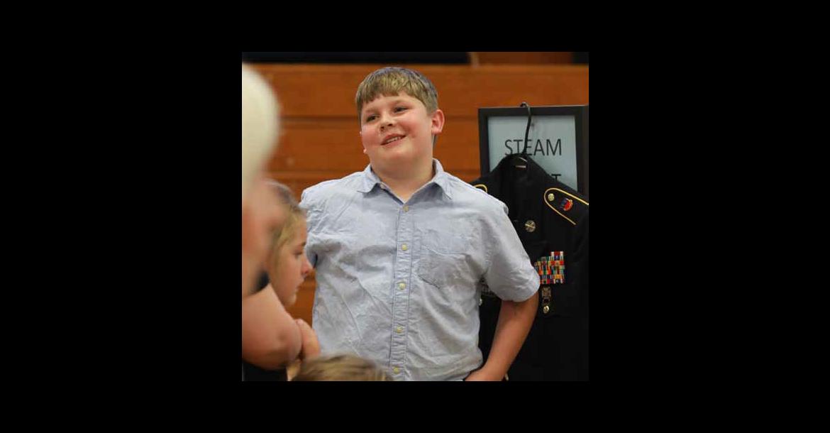Fifth grader Aiden Bayles shares information during Veterans Night Monday at Kanopolis Middle School. His presentation was about Kevin Lemieux. KAREN BONAR/Ellsworth County Independent-Reporter