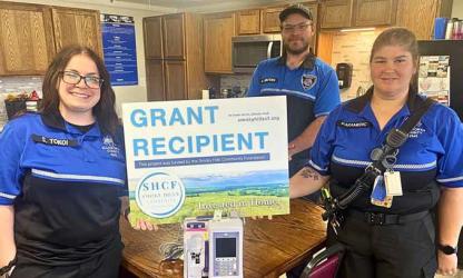 From left, EMT Scout Tokoi, paramedic Alex Winters and paramedic Elisabeth Mohler show the new IV pump purchased with grant funds. Courtesy photo