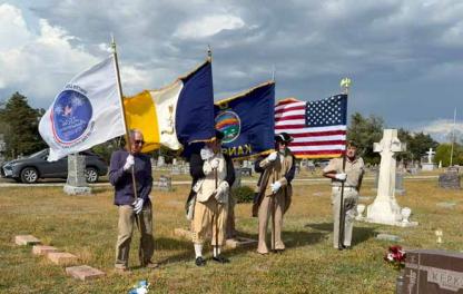 A variety of flags flap in the wind April 11 during the first Gold Star Mother ceremony at St. Wenceslaus Cemetery, Wilson. Pictured, from left, are Ron Svaty, John Moore, Bobbie Hulse and Doug Stefek. Courtesy photos