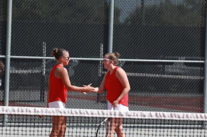 Junior Makenna Anderson, left, and senior Reygan Coonrod celebrate a point during the season opener in Ellsworth Sept. 1. 