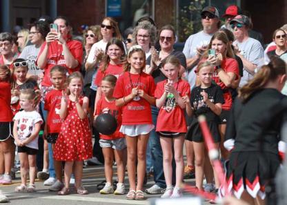 The crowd gathers at Douglas Avenue and East 1st Street while the homecoming candidates are introduced.