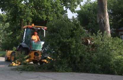 Ellsworth City Street Department employee Daren Webb clears a tree from West 2nd Street Tuesday morning. KAREN BONAR/Ellsworth County Independent-Reporter