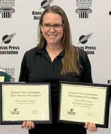 Karen Bonar displays sweepstakes awards for both the Ellsworth County Independent-Reporter and Marquette Tribune newspapers. WAYNE MIKOLS/Ellsworth County Independent-Reporter