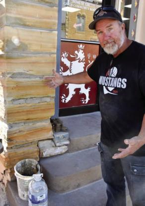 Jon Pancost, owner of Bluestem Quarry and Stone Works, Lucas, points out some of the concrete mortar his crew is replacing. CATHERINE DOUD/Ellsworth County Independent-Reporter