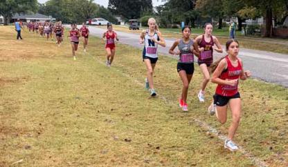 Freshman Mazie Barta leads the pack at the Hesston Invitational Sept. 10. She set a PR during the race. ERIC COONROD/Ellsworth County Independent-Reporter